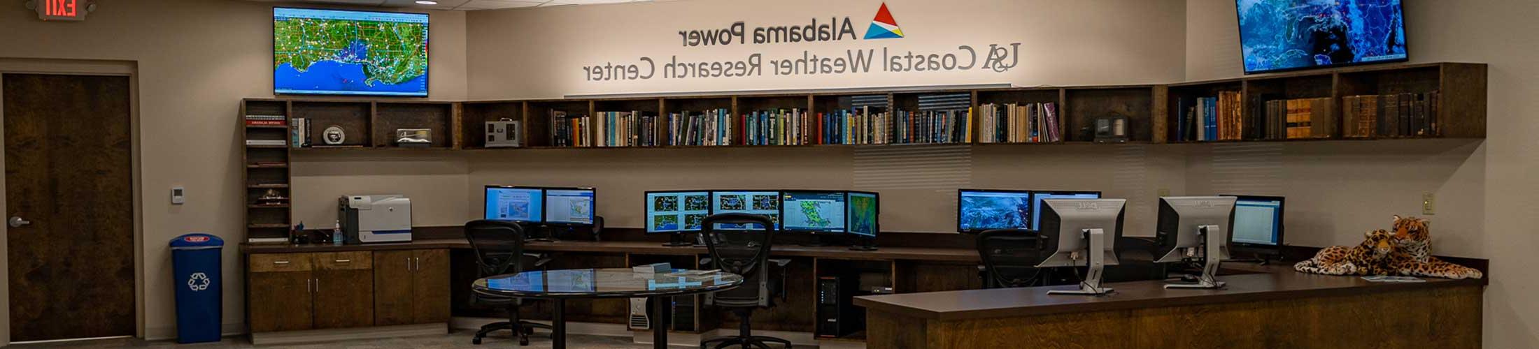 Alabama Power-USA Coastal Weather Research Center office displaying monitors.